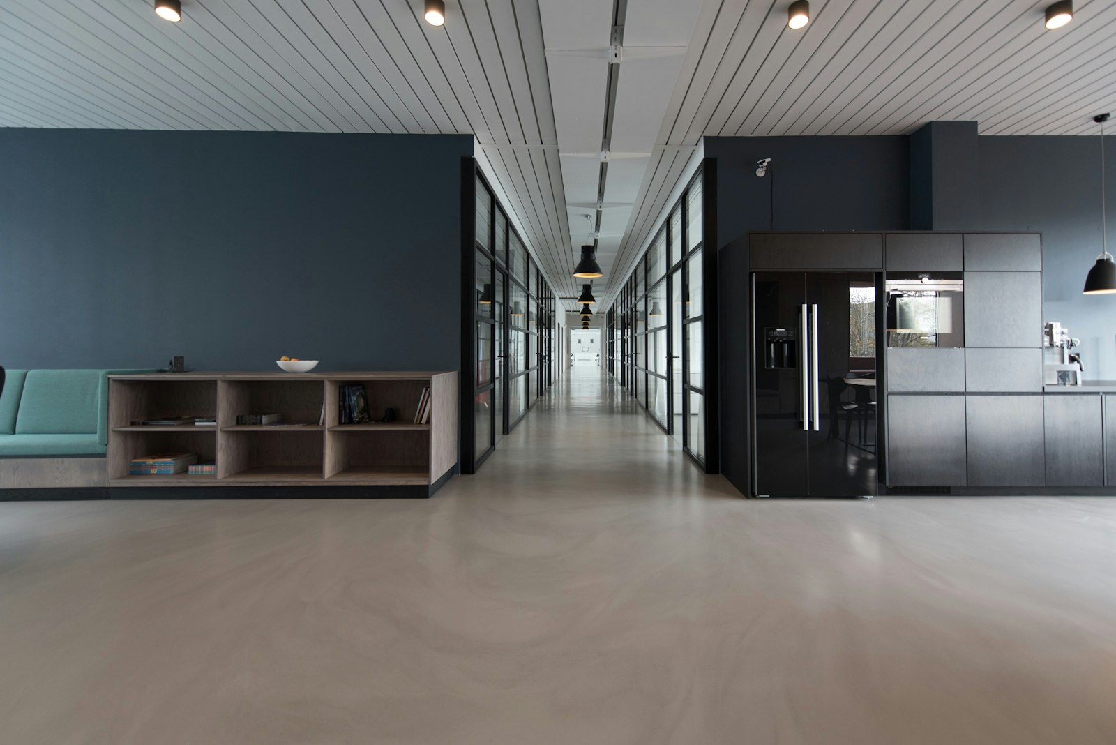 A bright, modern office workspace with desks and computer monitors